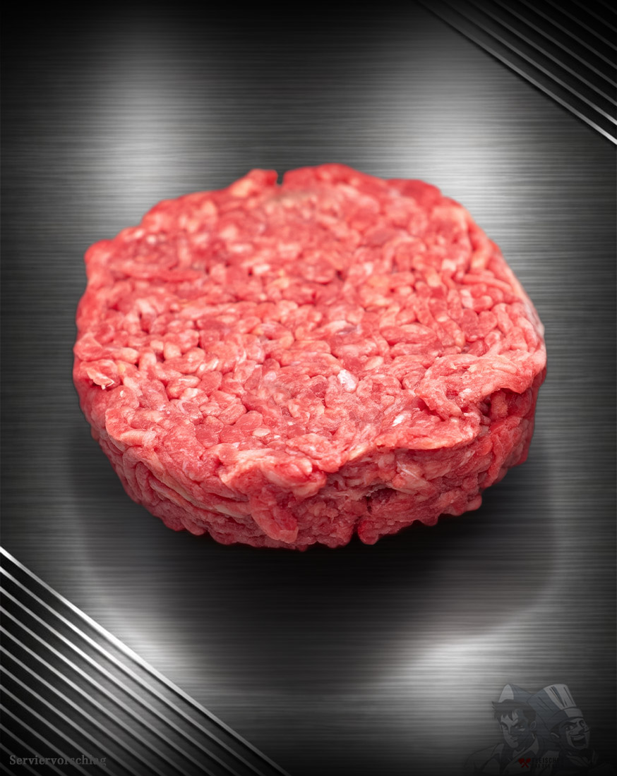 Haché Schweine-Burger Pattie aus Deutschland Rohes Haché Schweine-Burger Pattie aus grob gehacktem Schweinefleisch mit sichtbarer Struktur auf neutralem Untergrund.